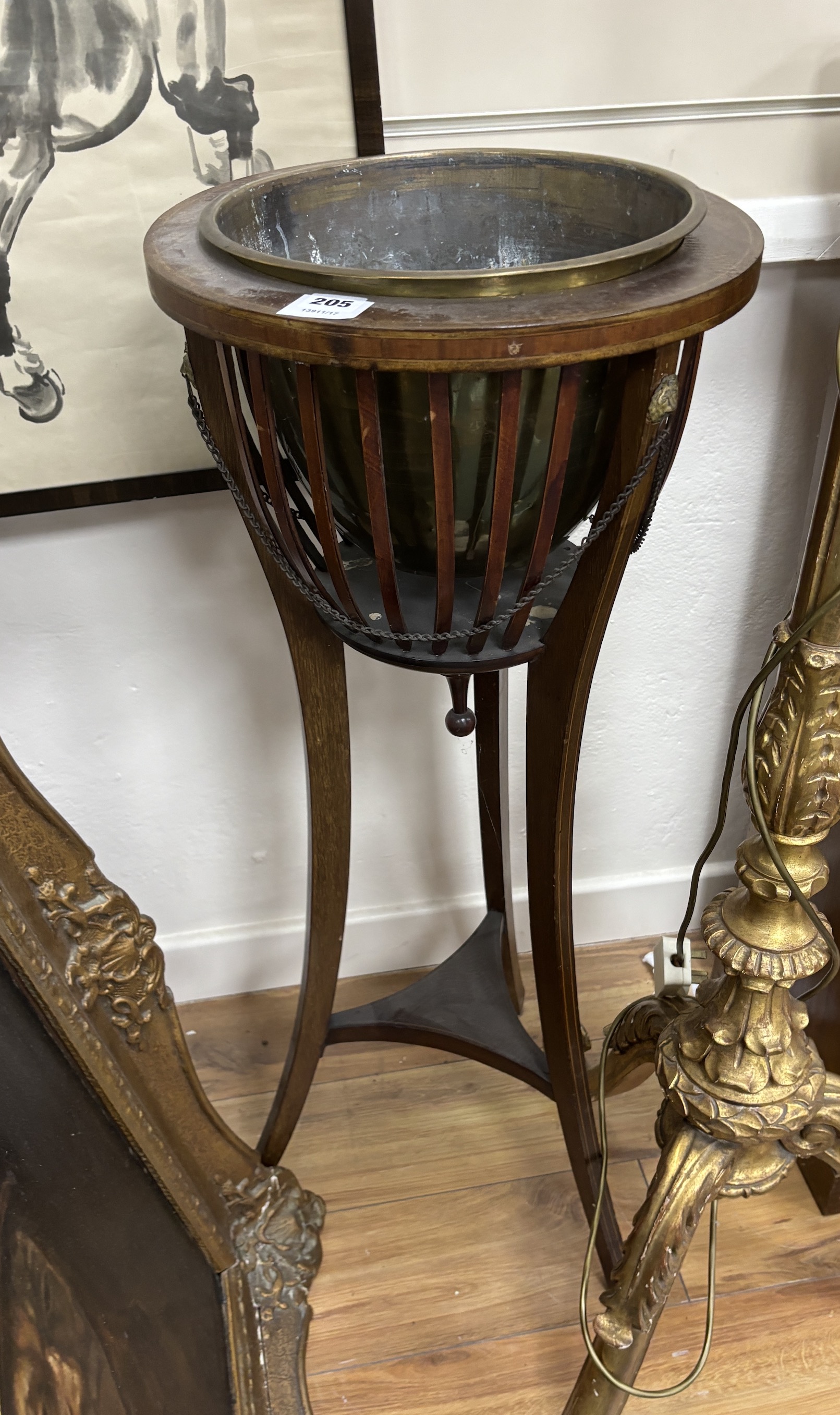 An Edwardian inlaid mahogany jardiniere with brass liner, diameter 37cm, height 93cm